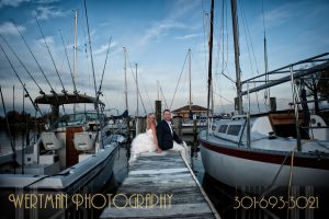 Bride and Groom sitting on a dock